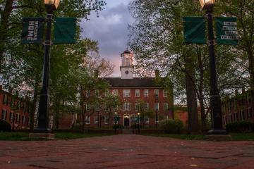 Cutler Hall and the College Green are shown in the evening