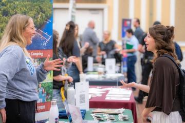 Megan Albers talks to an OHIO student at the Career Fair in the Baker University Center Ballroom