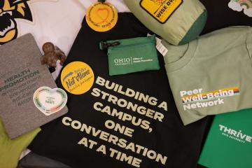 Shirts and buttons that say Peer Well-Being Network, THRIVE Ohio University, and Building a stronger campus, one conversation at a time