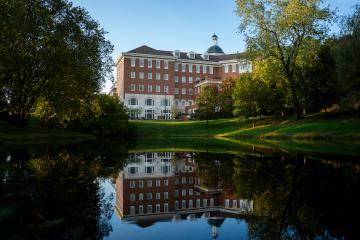 Baker University Center and the pond in front of it. The pond shows a reflection of the building