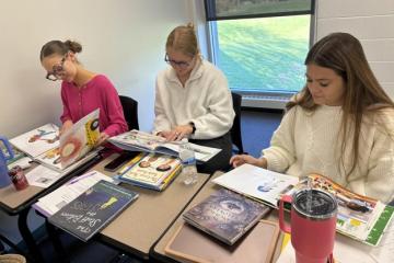 OHIO Lancaster students look through children's books for a class project