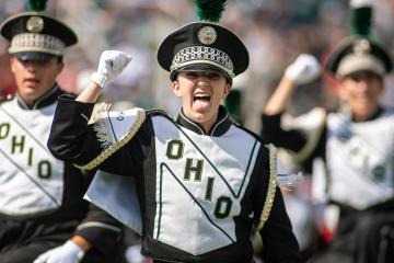 A Marching 110 band member pumps her fist excitedly