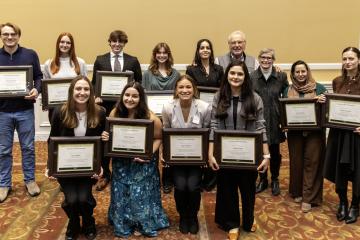 John Kopchick and Char Kopchick stand with the award winners, who are holding their awards