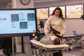 An MEA teaches medical students in the OMM lab