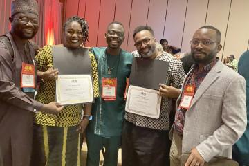 Five individuals pose with their awards