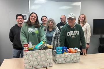 OHIO employees stand by boxes of food collected in the food drive