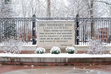 The Class Gateway is covered in snow, and the College Green is shown behind it, also covered in snow