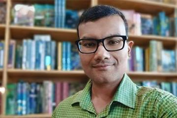 Dr. Dipayan Datta stands for headshot in his office at Ohio University 