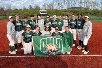 OHIO club softball team standing with an OHIO flag