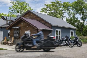 A motorcyclist rides past Triple Nickel Diner during lunch service in Chesterhill, Ohio. 