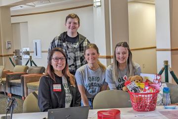 student nurses sit behind registration table at blood drive