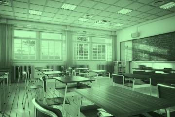 An image of an empty classroom with desks and chairs, and there is writing on the chalkboard