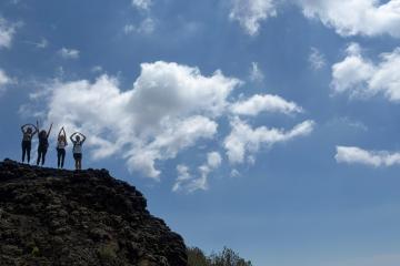 Photo of students spelling OHIO on top of mountain. 
