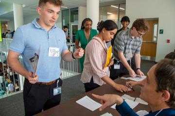 HCOM student visits station in Rethinking Poverty exercise