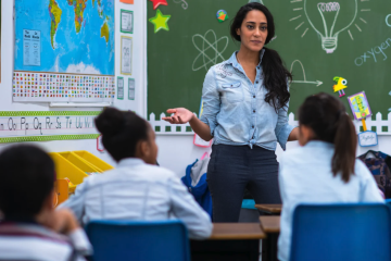 teacher standing in front of elementary classroom