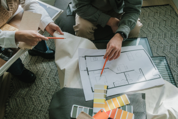 man and woman working on interior design project with samples