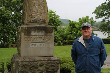 Jim Lee standing outdoors next to monument