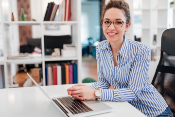 woman sitting at a desk with a computer