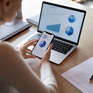 Woman uses assessment tools on laptop and phone