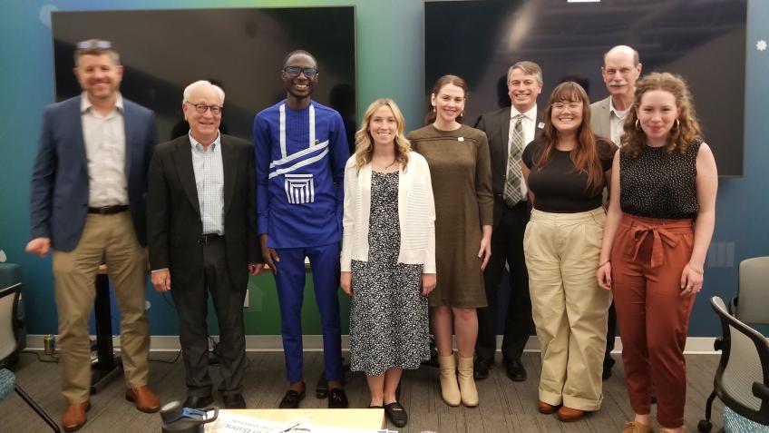 Cassidy Dummitt stands with a group of interns and officials during her summer internship.