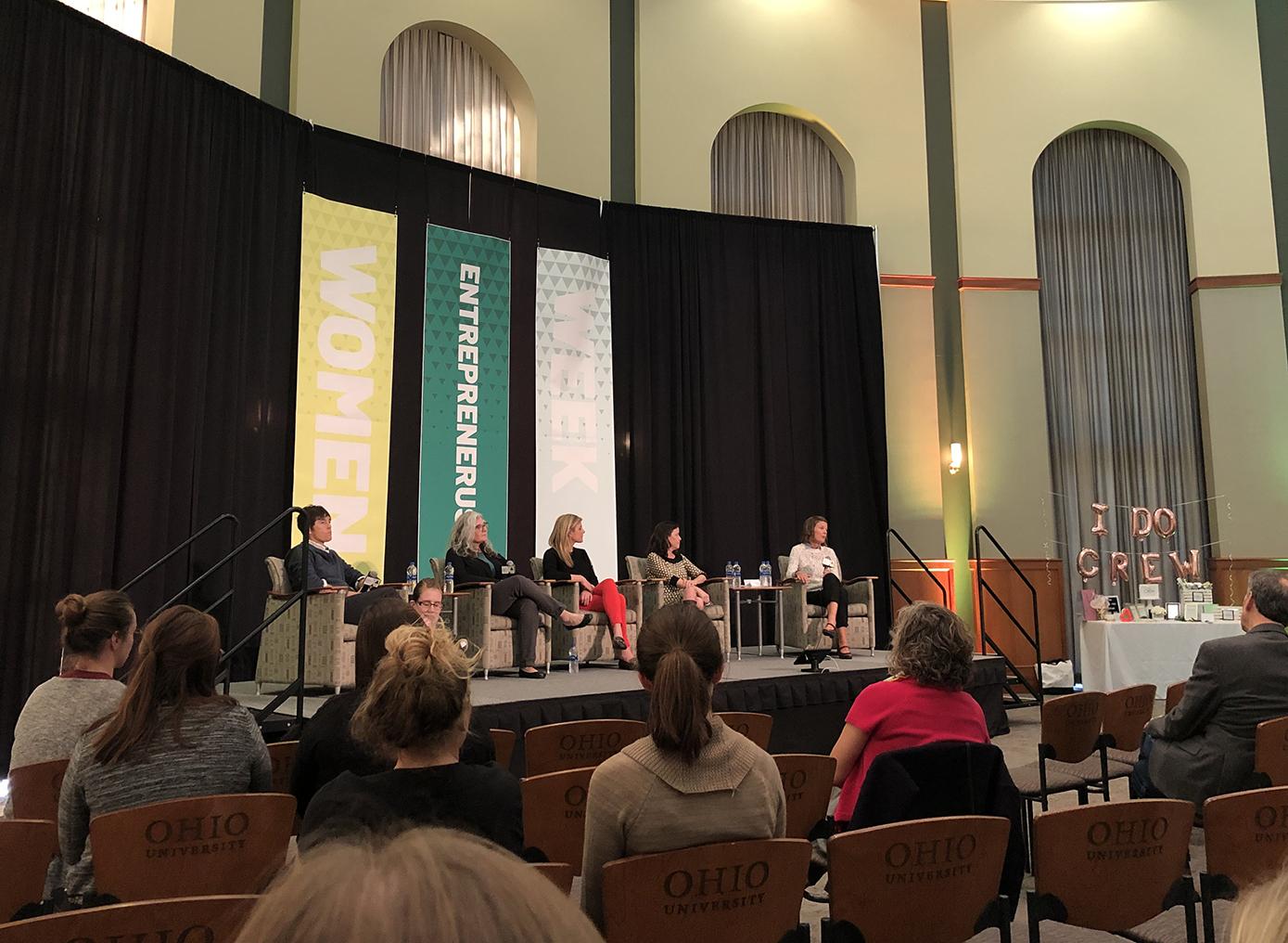 Women entrepreneurs speaking on a stage at the event.