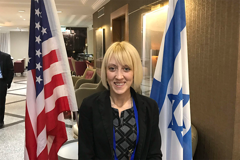 Amber Snowden standing in front of flags