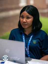 Woman working at a computer in an outdoor space